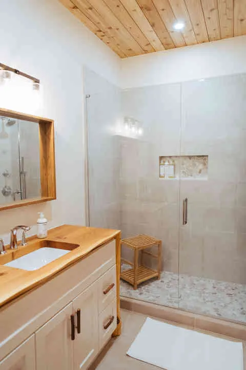 King bedroom en-suite featuring reclaimed wood countertops. 